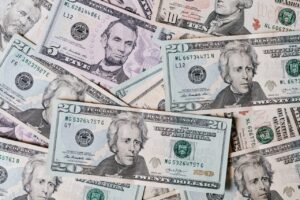 Top view of different types and colors American dollars placed together on each other